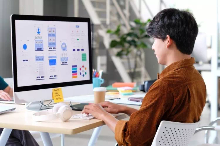 Personne travaillant sur ordinateur au design d'un site