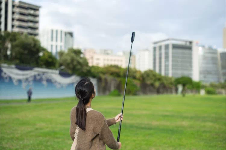 Jeune femme faisant une prise de vue avec une caméra 360°